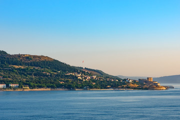 Fototapeta premium Entrance to Dardanelles (Canakkale strait) in morning haze from Aegean Sea with Ottoman fortress Kilitbahir ahead
