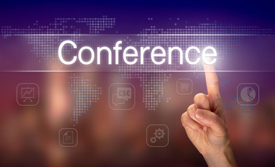 A hand selecting a Conference business concept on a clear screen with a colorful blurred background.