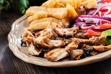 Greek gyros dish with french fries and vegetables