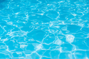Blue and bright ripple water and surface in swimming pool, Beautiful motion gentle wave in pool