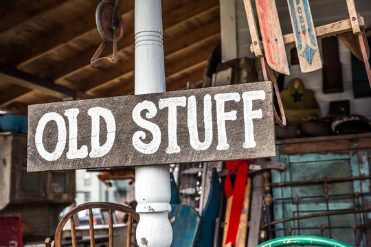 Vintage “Old Stuff” Wood Sign on White Wood Post.