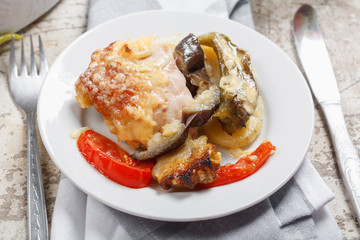 Traditional rustic stew of chicken and vegetables on plate with tomatoes, peppers