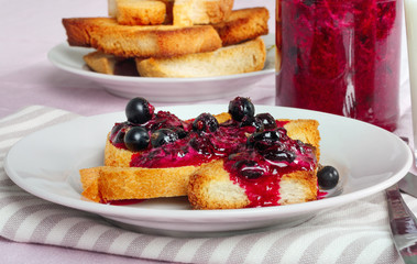 Delicious toasts bread with homemade currant jam with fork and knife