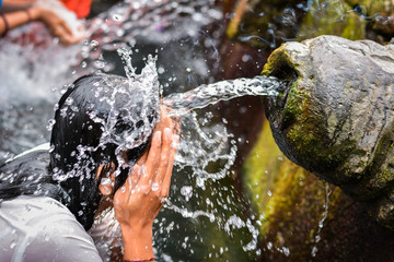 balinese people taking a holy bath at pura tirta empul