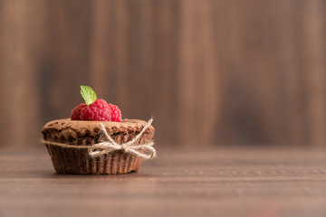 Delicious chocolate lava cake with fresh raspberries and mint on the table