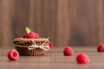 Delicious chocolate lava cake with fresh raspberries and mint on the table