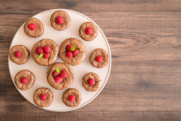 Delicious chocolate lava cakes with fresh raspberries and mint, on the plate
