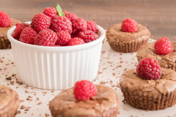 Chocolate lava cakes with fresh raspberries, mint and chocolate pieces