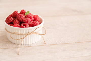 Bowl of fresh raspberries and mint leaf