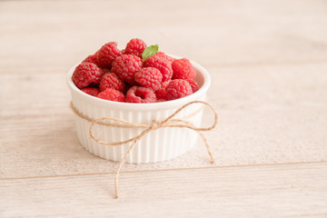 Bowl of fresh raspberries and mint leaf