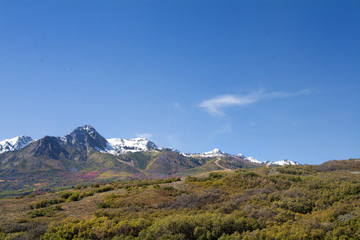 Utah Mountain peak near ski resort with snow capped peaks and fall leaves