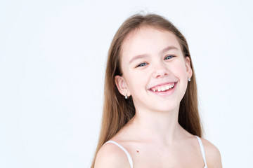 emotion face. joyful beautiful child with a wide smile. little girl portrait on white background....