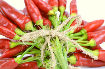 colorful of red chili peppers group  Tied with hemp rope on white background.
The pepper heat helps to stimulate secretions  clearing your nose,  antibacterial.