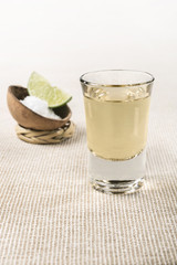 Authentic shot of Tequila Mexican traditional drink accompanied with lime and salt