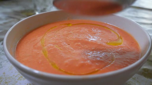 Fresh and tasty A bowl of Salmorejo. Typical summer meal, puree consisting of tomato and bread, originating from Cordoba in Andalucia, south Spain. It is made from tomatoes, bread, oil, garlic.