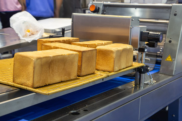 Bread / toast slicer machine cutting bread into strip in food and bakery production line