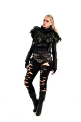 full length portrait of blonde girl wearing torn black feather costume. standing pose, isolated on white background.