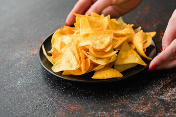 junk fast food and unhealthy eating. crispy chips. woman hands holding a bowl of crunchy crisps