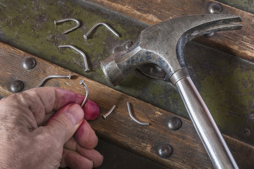 Carelessly hammering on bent nails Bending nails because you hit them without proper skills 