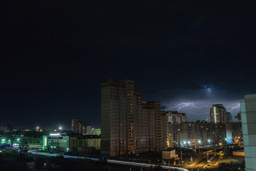 Fototapeta na wymiar lightning over the city at night