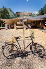Rusty Bicycle and Wooden Photo Booth Direction Sign at Shabby Chic Wedding.