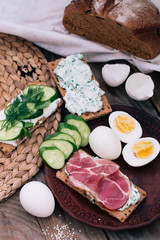 Italian style lunch jamon snack decorated with boiled eggs and cucumbers.