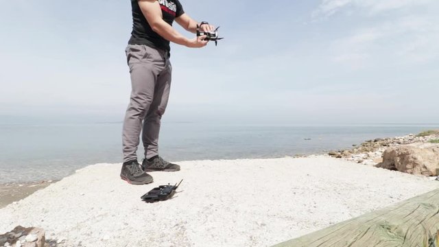 Man setting up and flying drone