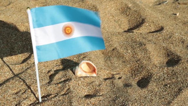 Flag of Argentina on a sandy beach.
