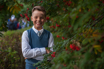 The first time in first class: happy schoolboy at school background