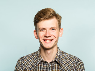 handsome smiling joyful content glad man portrait of a young guy on light background. emotion...