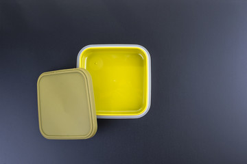 A set of clean plastic lunchboxes. Trend for the office. Black background. New dishes. Copy space.
