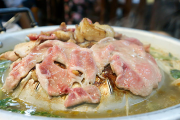 barbecued pork or raw pork in the pan