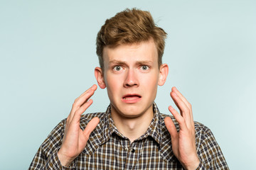 oh no. terrified shocked desperate alarmed dismayed man in distress. portrait of a young guy on...