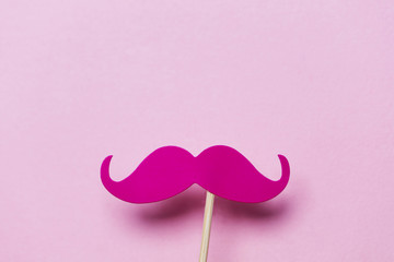Pink moustache on a pink background. Modern masculinity concept