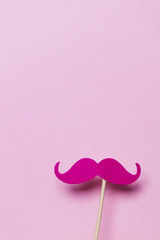 Pink moustache on a pink background. Modern masculinity concept