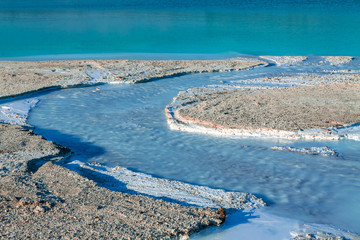 The river delta entering the turquoise lake