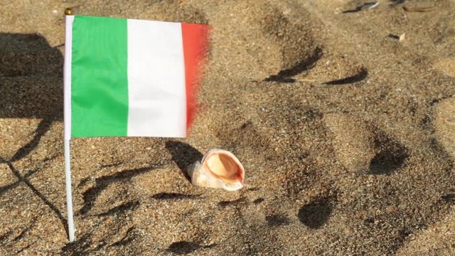 Flag of Italy on a sandy beach.