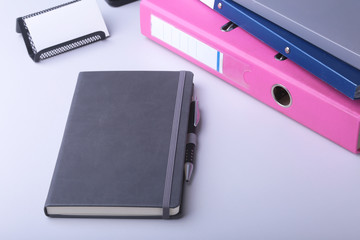 Folder file, note and pen on the desk. blurred background.