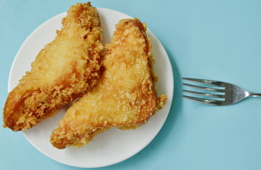 crispy fried sandwich stuffed tuna and imitation crab stick on white plate