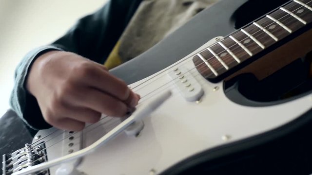 Playing the electric guitar close up