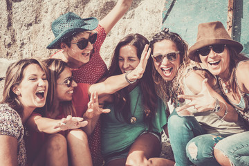 group of crazy nice beautiful caucasian girls outdoor under the summer sun doing a party all together. people having fun iall together oncept lifestyle. shout and laugh full of joyful women