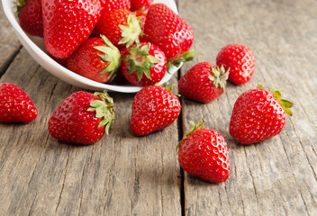 Ripe red strawberries on wooden table