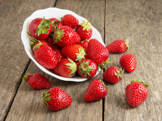 Ripe red strawberries on wooden table