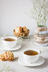tea served in white cup on white table. Hot drink for winter. Selective focus