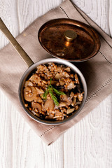 Buckwheat porridge with mushrooms in the copper pan