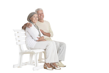 portrait of  senior couple sitting on bench