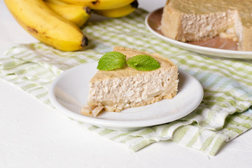 Banana cream pie on a white plate