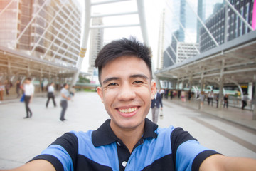 Happy man take photo selfie in city outdoor