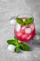delicious strawberry cold drink with ice and mint in glass on white background