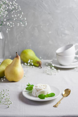 Panna Cotta, traditional sweet Italian dessert, with mint and pear
